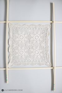 old doily stretched on a frame