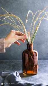 photo of the amber brown glass vase and wheat