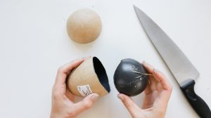 cutting a paper mache egg for the acorn ornament