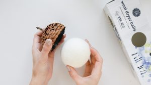 attaching a wool dryer ball to create an acorn ornament
