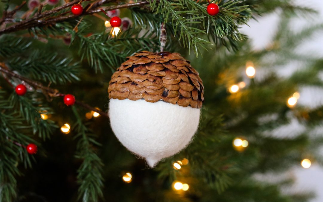 acorn ornament hanging on a christmas tree