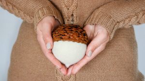 holding an acorn ornament
