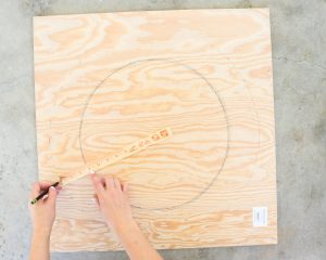 marking a circle with a ruler on plywood