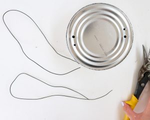 tin can with holes and two pieces of wire